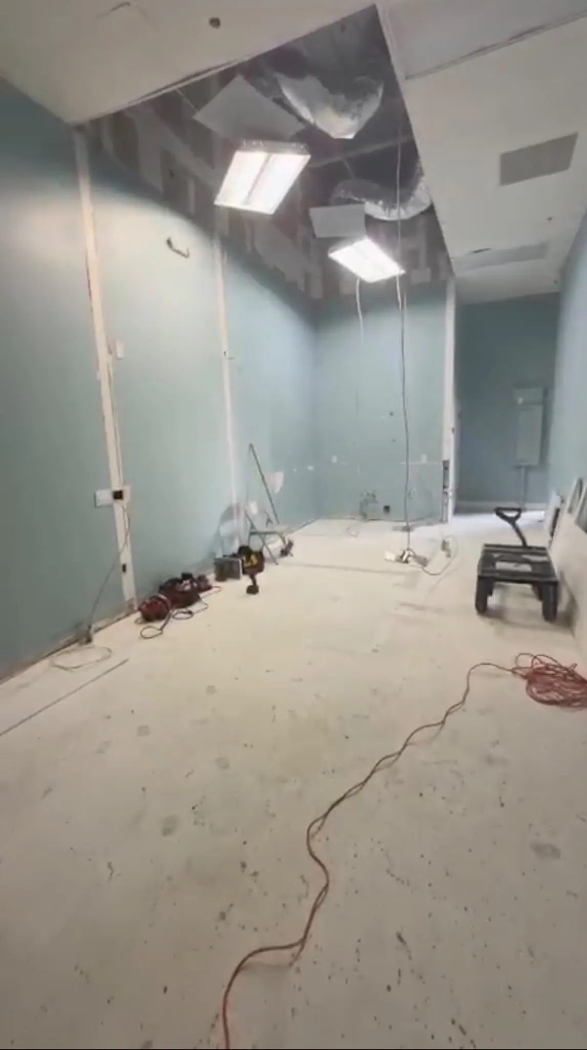 Commercial interior after demolition, with the ceiling opened and bare floor